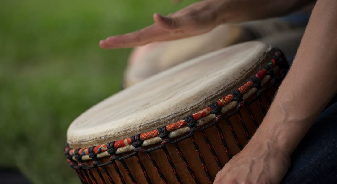 Close-up of an African drum with hands