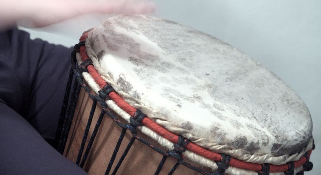 Close-up of a djembe with hands