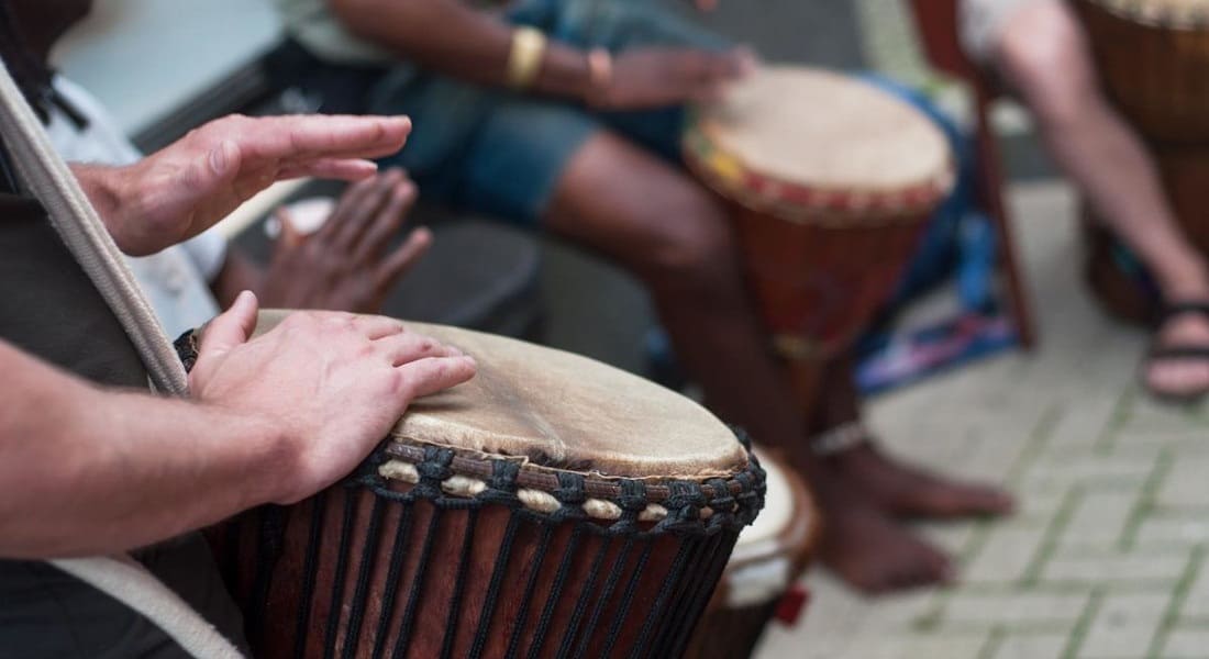 Close-up of the hands in a djembe ensemble