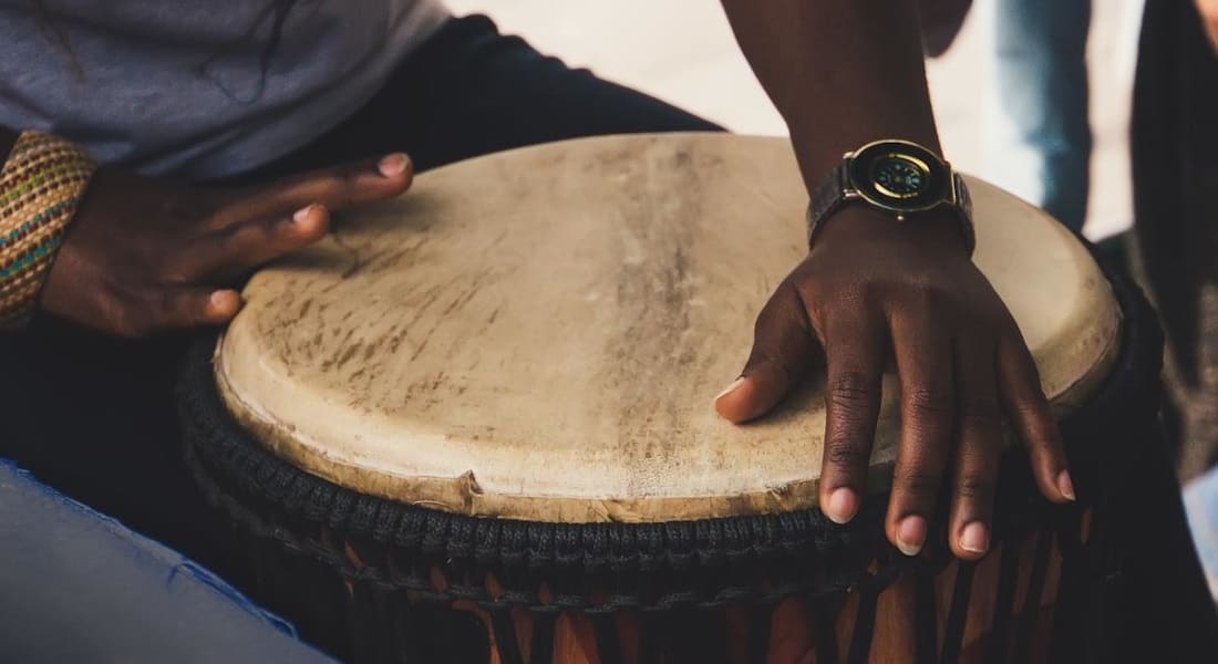 Close-up of two hands with an African drum