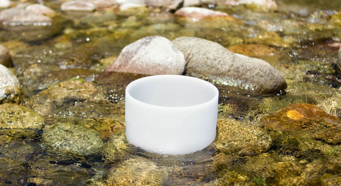 A crystal singing bowl in a river