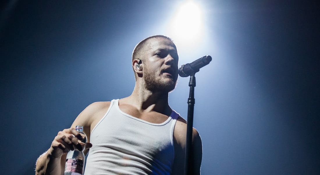Dan Reynolds singing into a microphone