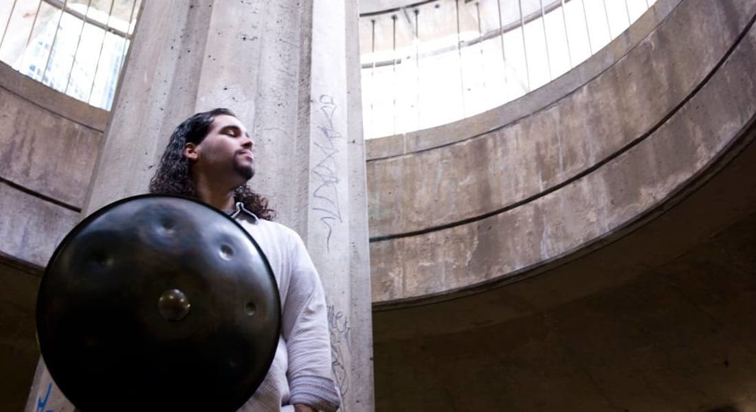 Dante Bucci, eyes closed, with a handpan