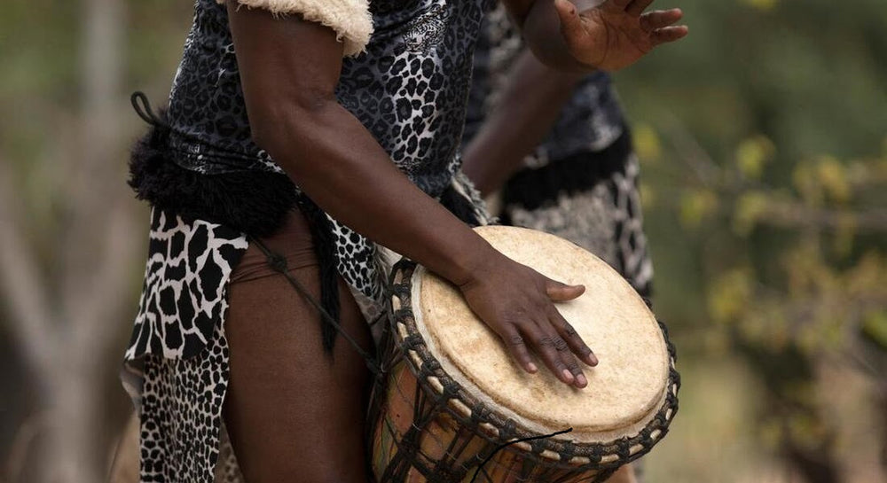 Djembe played by a Black African man