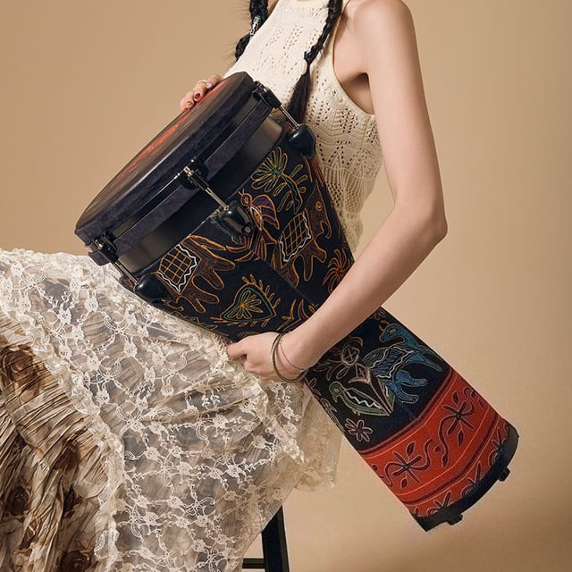 Synthetic-skin djembe held in hand
