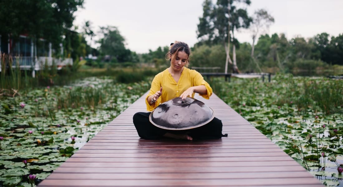 A handpan musician on a bridge