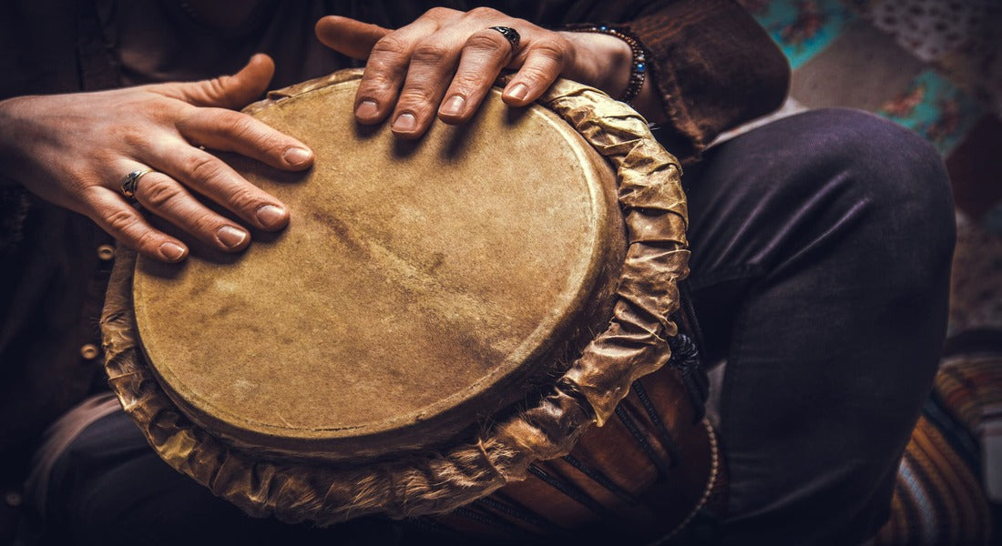 Hands playing the djembe