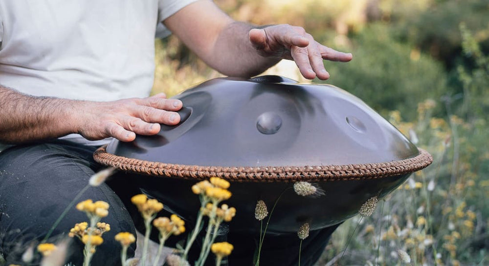 A pair of hands playing the handpan