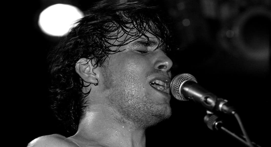 Jeff Buckley singing in front of a microphone