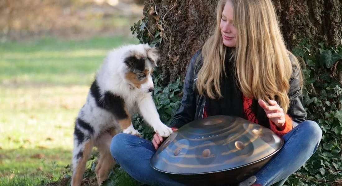 Kate Stone with a handpan and her dog