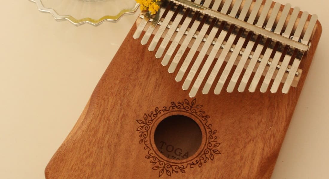 A close-up of a light wood kalimba