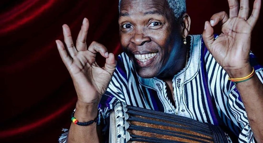 Mamady Keïta smiling with a djembe