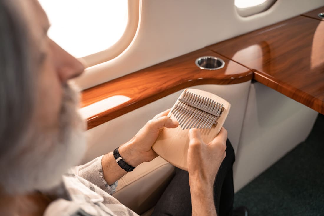 A man with a beard playing the kalimba