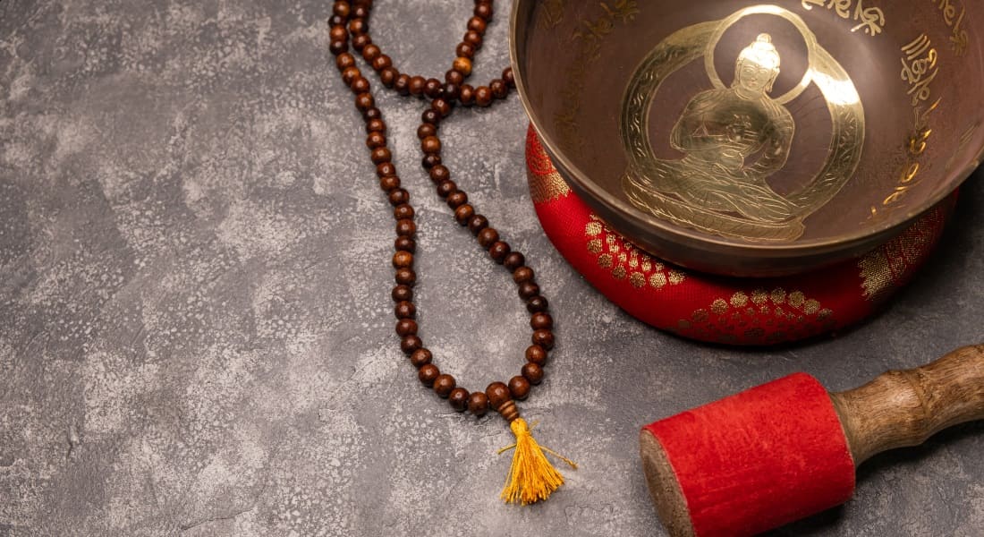 A metal Tibetan singing bowl with a Buddha engraving