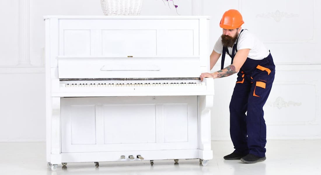 A mover pushing a piano