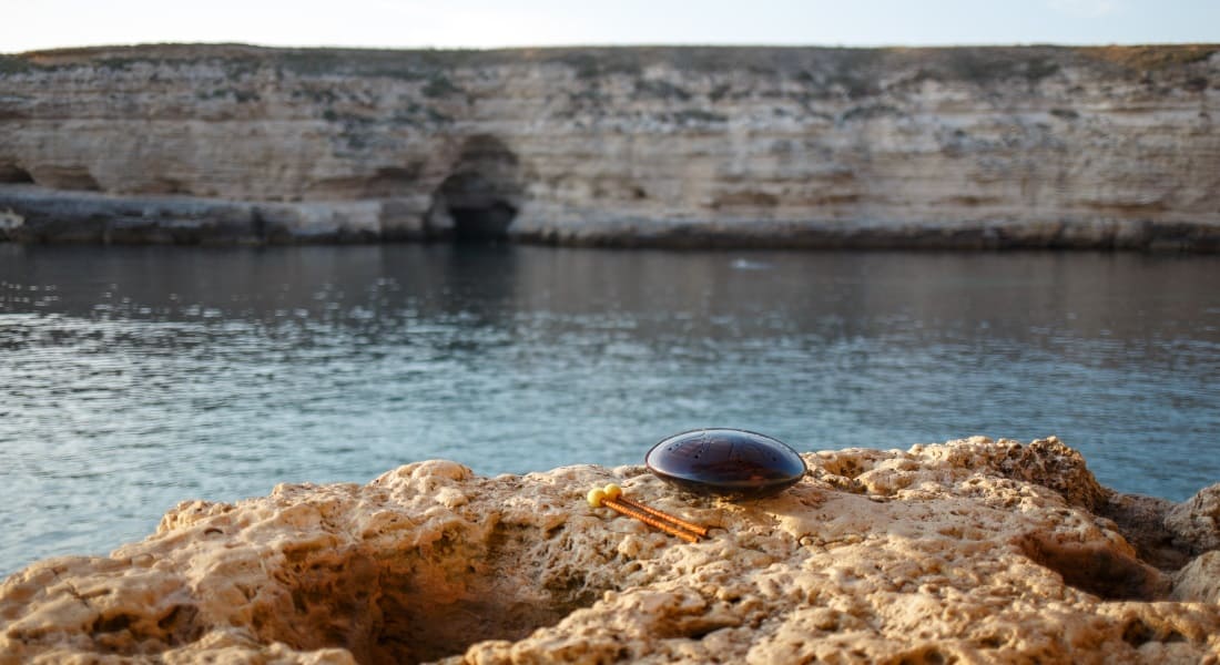 A steel tongue drum placed on a reef