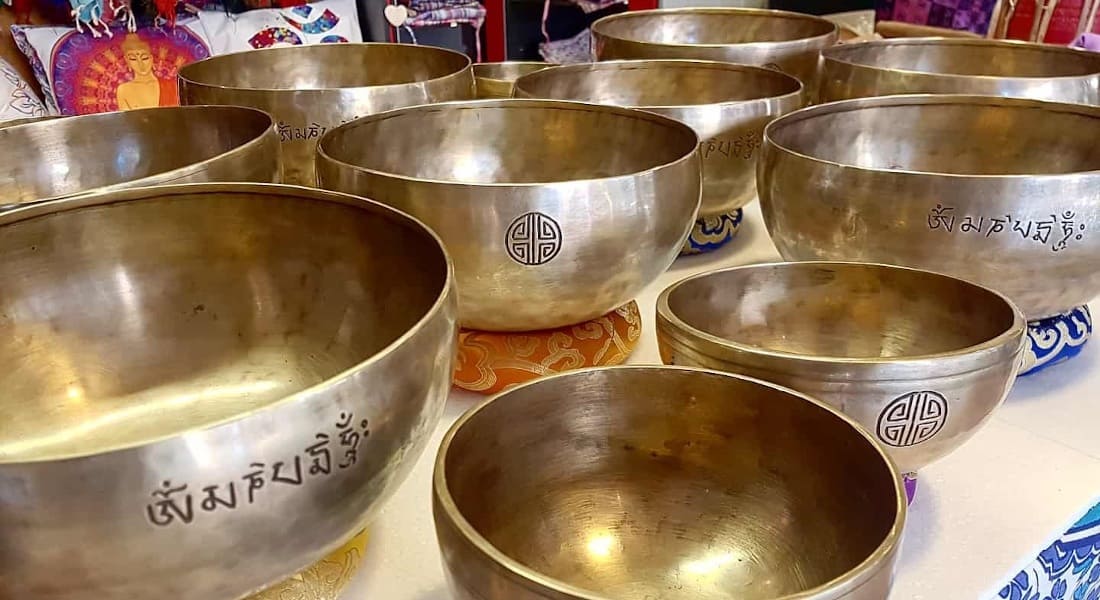 About ten Full Moon singing bowls displayed on a stall