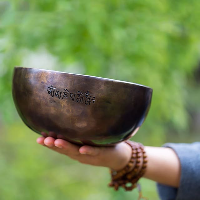 Healing Tibetan singing bowl held in hand