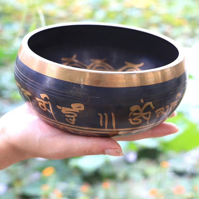 Tibetan singing bowl note E held in hand