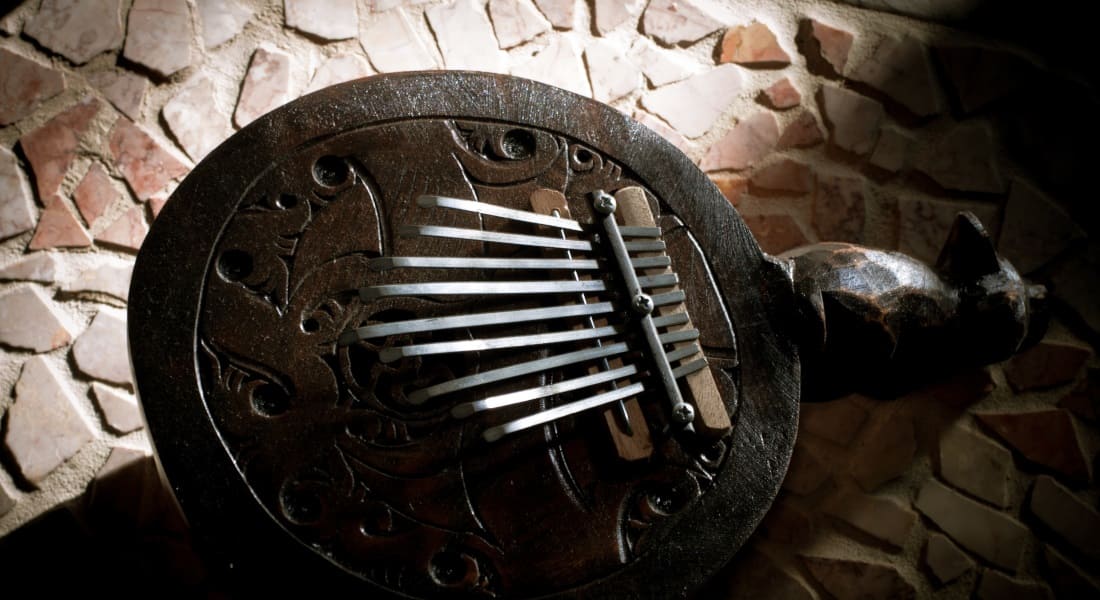 A traditional kalimba with a handle