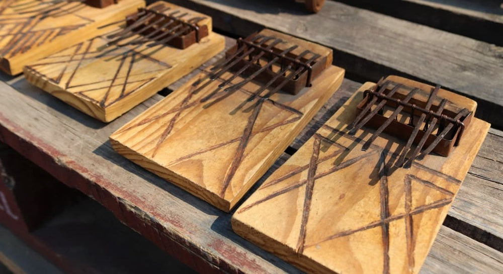 Several traditional kalimbas lined up on a table