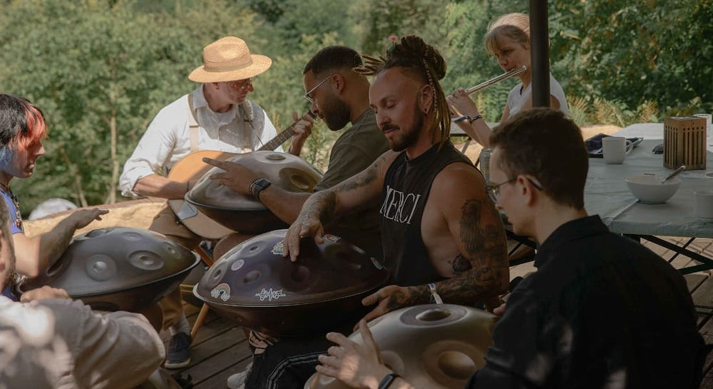 Warren Shanti playing handpan at a festival with other musicians