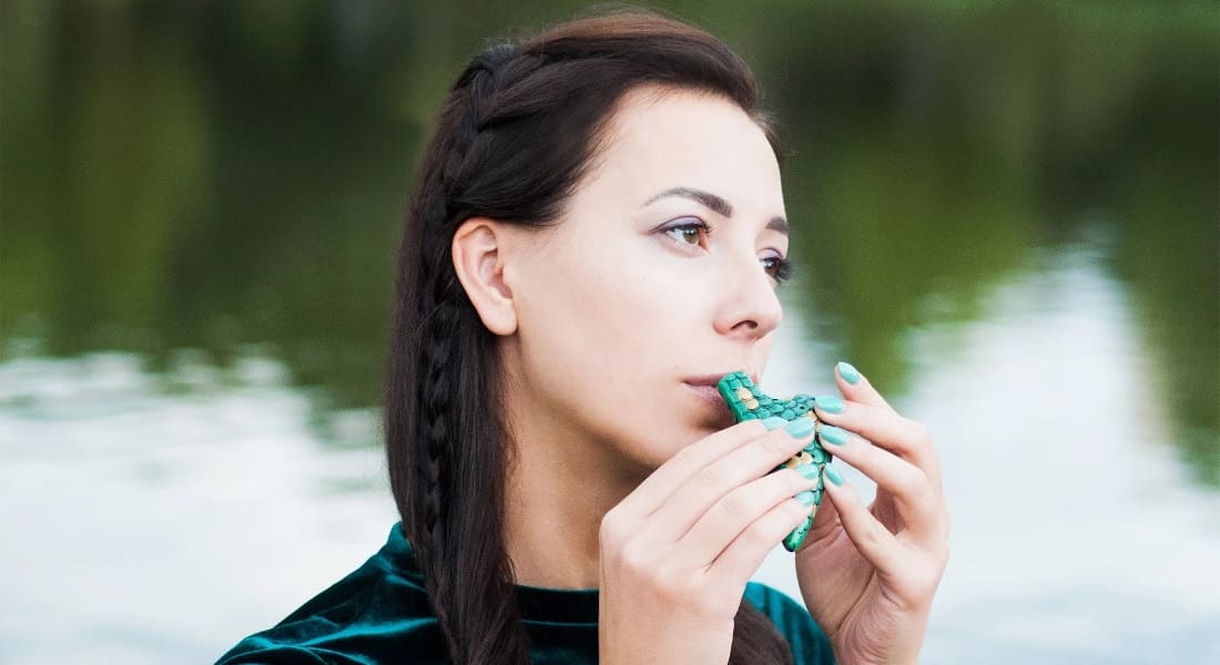 A woman playing a green ocarina