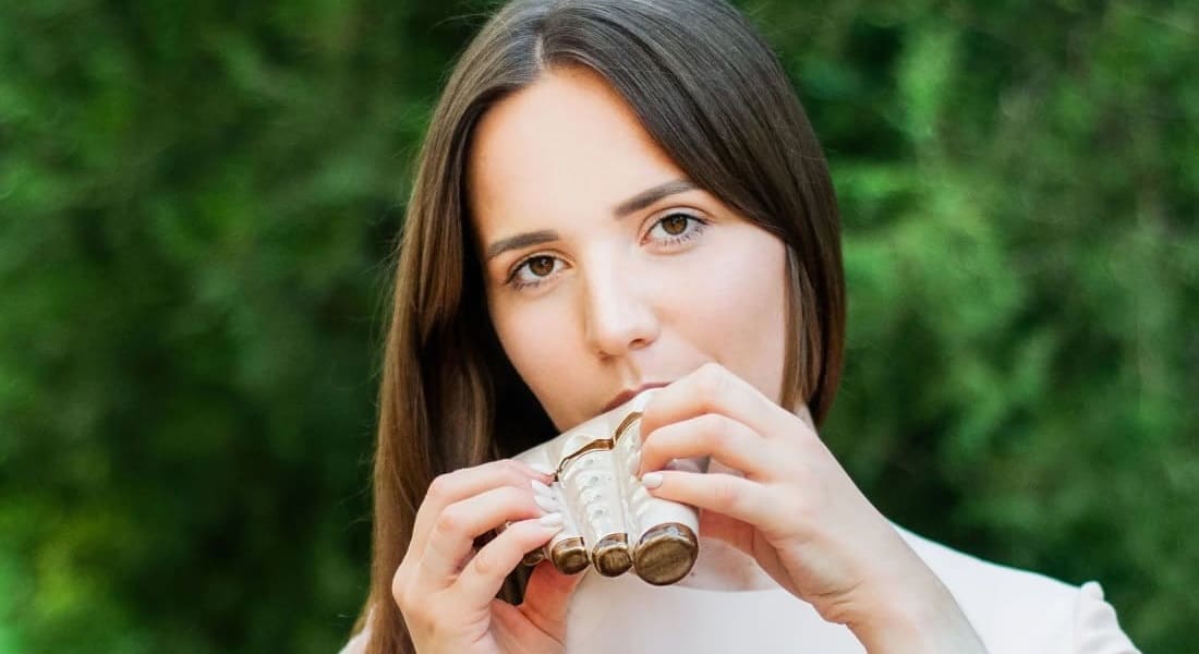 A woman using a triple ocarina