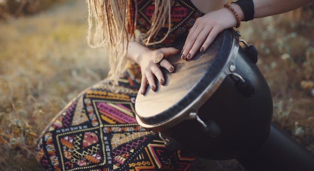 A woman with a tension-rod djembe